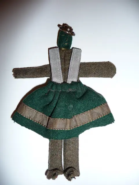 A simple handmade cloth doll with a plain stitched face and dress, unadorned by any specific cultural styling
