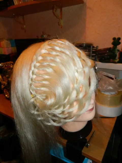 A braided blonde wig mounted on a mannequin head