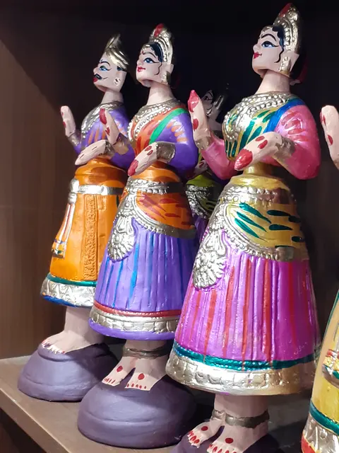 A pair of Thanjavur dancing dolls (thalaiyatti bommai) from Tamil Nadu, India